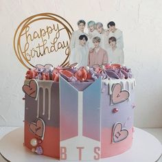 a birthday cake with the bts on it's side and an image of two people in the background