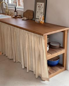 a kitchen with a sink and wooden counter top