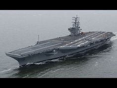 an aircraft carrier in the middle of the ocean