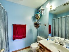 a bathroom decorated with balloons and streamers for the party guests to use in their own home