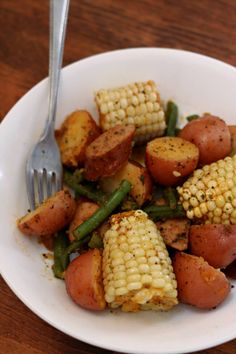 a white plate topped with corn and potatoes