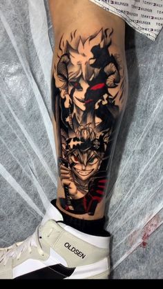 a man's leg with a tattoo on it and an image of a demon