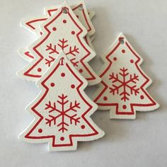 three red and white christmas tree ornaments