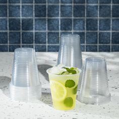 several plastic cups with lemon slices and ice