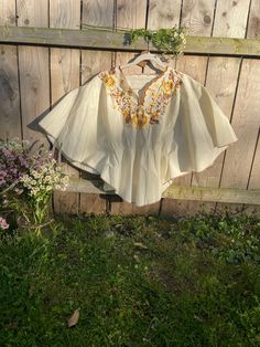 Vintage 1970s embroidered floral beige blouse. butterfly style sleeves.  scalloped neckline and cinched in the waist with elastic in very good condition Condition: very good condition; embroidery is in great condition - all intact  Measurements (taken laying flat and then doubled where applicable): 44 inches pit to pit, but can go up to 50inches as sleeves are open  22 inches length **Follow us on Instagram for first dibs and new vintage drops @vintage_andflora ** All vintage items are sold as is. They are preloved and you should expect some typical wear. If anything to call-out it will be mentioned in the condition section. All items are cleaned and steamed. Please ask any questions before purchasing as all sales are final. Vintage Beige Festival Tops, Vintage Beige Blouse For Spring, Beige Floral Embroidery Tops For Festival, Folk Style Cream Top With Floral Embroidery, Folk Style Cream Tops With Floral Embroidery, Cream Folk Tops With Floral Embroidery, Folk Style Beige Tops With Floral Embroidery, Vintage Cream Tops With Floral Embroidery, Vintage Cream Top With Floral Embroidery