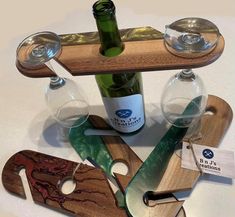 wine glasses, bottle openers and corkscrews are arranged on a table