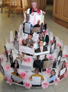 a cake decorated with pictures of people on it's sides and pink flowers in the middle