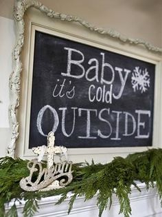 a chalkboard with the words baby it's cold outside written on it in white