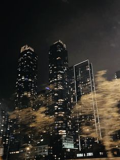 the city skyline is lit up at night