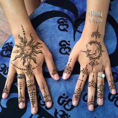 two hands with henna tattoos on them