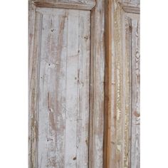 an old wooden door with peeling paint on it