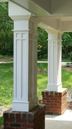 an outdoor covered patio with brick pillars and columns