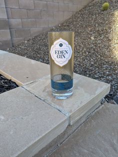 an empty glass sitting on top of a cement block