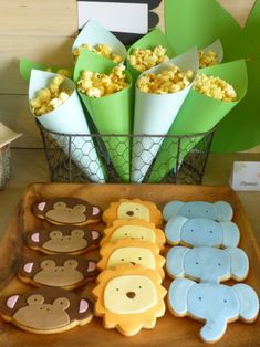 some cookies are sitting on a tray with cupcakes