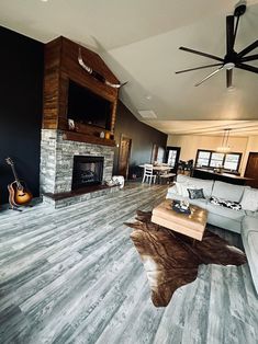 a living room with wood flooring and a ceiling fan