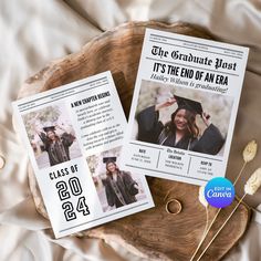 two graduation pamphlets sitting on top of a wooden tray next to some dried flowers and leaves