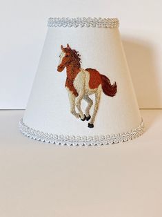 a lamp shade with a horse on it