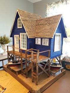 a doll house is sitting on top of a table