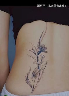 a woman's stomach with a flower tattoo on her belly and the bottom part of her lower back