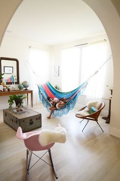 a hammock hanging in the middle of a living room