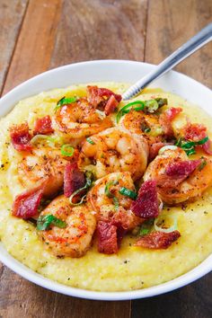 shrimp and grits with bacon in a white bowl