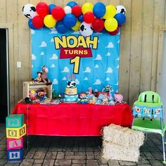 there is a table with balloons and other items on it at a birthday party for noah