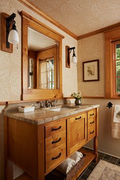 a bathroom with double sinks and wooden cabinets