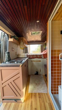 the inside of a tiny home with wood flooring and tile on the walls,