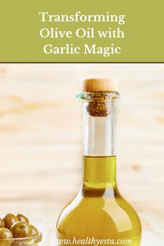 an olive oil bottle and some green olives on a wooden table with text overlay reading transforming olive oil with garlic magic