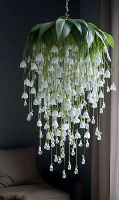 a chandelier with white flowers hanging from it's ceiling in a living room