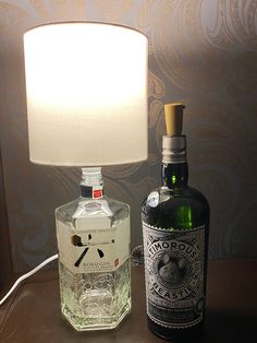 a bottle of liquor next to a lamp on a table