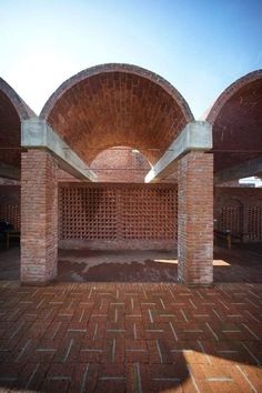 an empty room with brick walls and arches