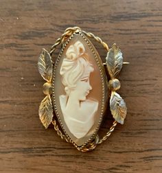 This is a vintage marquis shaped Catamore cameo brooch that is 1/20 12K gold filled. It is approximately 1-1/2 inches long and 1 inch wide. There are some small imperfections due to its age. It has an extra long pin. Antique Marquise Gold Jewelry, Vintage Gold Marquise Jewelry, Vintage Marquise Gold Jewelry, Heirloom Cameo Brooches For Collectors, Victorian Cameo Brooch For Anniversary, Vintage Oval Brooches For Collectors, Antique Cameo Brooches Collectible, Luxury Classic Cameo Brooches, Vintage Oval Gold Brooches