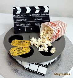 a movie themed cake with popcorn and tickets