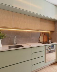 a kitchen with green cabinets and white counter tops