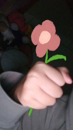 a person holding a flower in their hand with the image of a pink flower on it