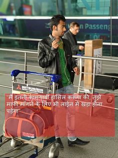 a man standing next to a cart with luggage on it and talking on the phone