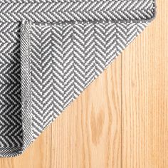 a black and white checkered table cloth on top of a wooden floor