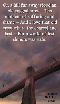 a wooden cross with a bible verse written on the front and bottom, against a cloudy sky