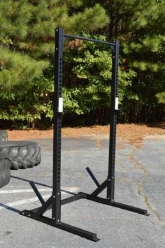 a pair of black squat stands in the middle of a parking lot next to tires