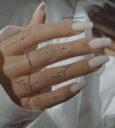 a manicured hand with stars and leaves on it