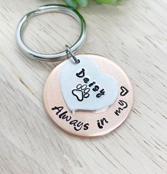 a keychain with a dog's paw and heart on it