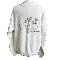 VIntage Bill Blass men's golf sweater ivory cream in color nubby / textured material embroidered golfer at hole 18; Scottish Isle crew neckline and tighter waist long sleeve tag reads, "Bill Blass Menswear"  100% cotton hand framed made in the USA Size: L; Armpit to Armpit {front side} - 25"; Waistband {front side} - 17"; Length From Back Shoulder - 28"  Double any "front side" measurements Condition: Preowned; light wear Golf Sweater, Bill Blass, Back Shoulder, Mens Golf, Made In The Usa, Crew Neckline, Golf, Crew Neck, Long Sleeve