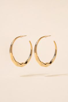 These captivating earrings feature a unique abstract design that adds a contemporary touch to your ensemble. The glossy finish enhances the modern aesthetic, catching the light and reflecting a subtle shine. The open hoop design adds an element of elegance and versatility, making these earrings suitable for both casual and formal occasions. SizeHeight: 1.75 in (4.45 cm)Width: 1.75 in (4.45 cm) Quality Made of a strong metal alloy, ensuring its longevity and quality. Secured with a post backing m Modern Open Circle Pierced Hoop Earrings, Modern Hoop Earrings With Shiny Finish, Modern Metal Small Hoop Wrap Earrings, Modern Small Hoop Pierced Earrings, Modern Geometric Metal Hoop Earrings, Modern Metal Small Hoop Earrings, Modern Metal Open Circle Hoop Earrings, Modern Pierced Hoop Wrap Earrings, Modern Shiny Hoop Earrings Gift