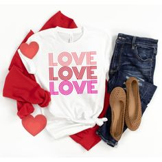 a t - shirt with the words love and hearts on it next to some jeans