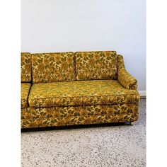 a yellow couch sitting on top of a white floor