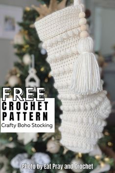 a crocheted christmas stocking hanging from a tree with the text free crochet pattern