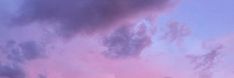 an airplane is flying in the sky at sunset or dawn with pink clouds above it