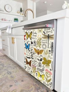 a kitchen with white cabinets and butterflies on the doors