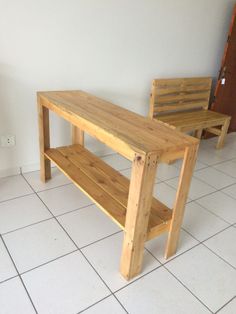 a wooden bench sitting on top of a white tiled floor